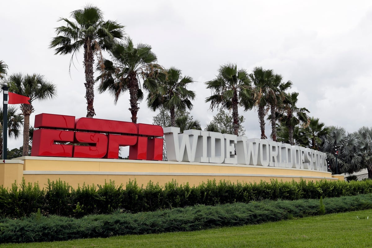 A sign marking the entrance to ESPN's Wide World of Sports at Walt Disney World is seen Wednesday, June 3, 2020, in Kissimmee, Fla. The NBA has told the National Basketball Players Association that it will present a 22-team plan for restarting the season at Disney. (AP Photo/John Raoux)