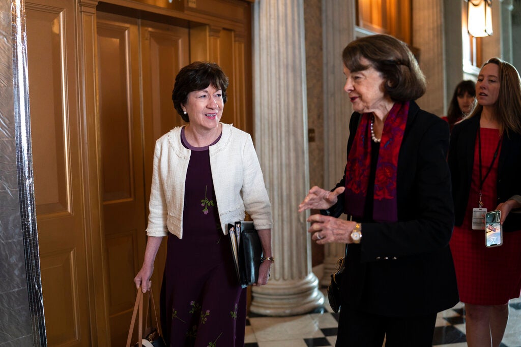 Sen. Susan Collins, R-Maine, left, speaks with Sen. Dianne Feinstein, D-Calif., as senators arrive before a procedural vote on the Women's Health Protection Act to codify the landmark 1973 Roe v. Wade decision that legalized abortion nationwide, at the Capitol in Washington, Wednesday, May 11, 2022. President Joe Biden called on Congress to pass legislation that would guarantee the constitutional right to abortion services after the disclosure of a draft Supreme Court opinion that would overturn Roe v. Wade. (AP Photo/J. Scott Applewhite)