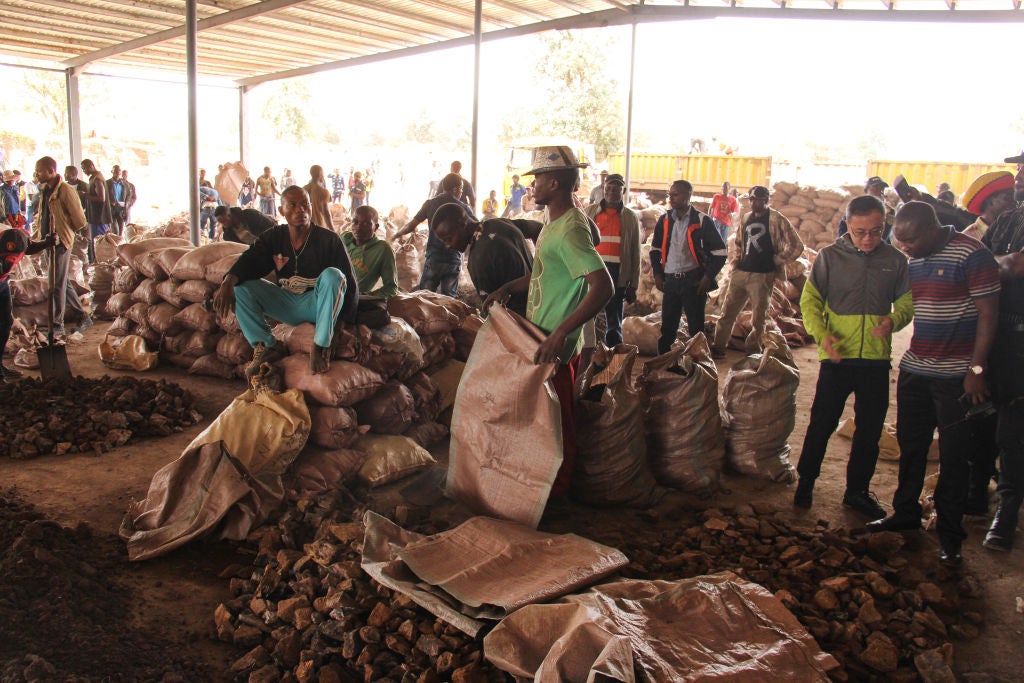 Men sort through and bag cobalt ore ahead of its sale to Congo Dongfang International Mining Sprl, a subsidiary of Zhejiang Huayou Cobalt Co. Ltd., at the marketplace at the Kasulo township in Kolwezi, Democratic Republic of the Congo, on Saturday, Feb. 24, 2018. So-called artisanal mining is as commonplace as farming in many parts of Congo. Photographer: William Clowes/Bloomberg via Getty Images