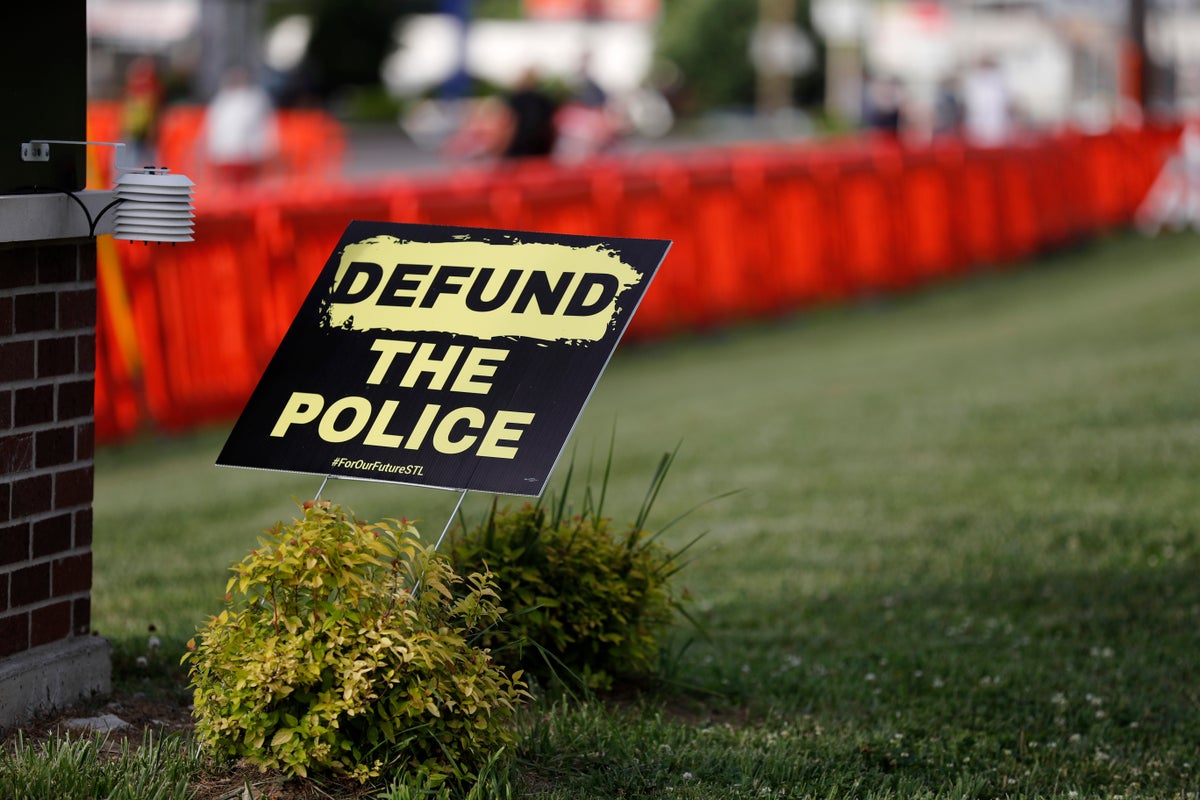 A sign advocating for defunding the police is seen outside the police station Wednesday, June 10, 2020, in Florissant, Mo. Demonstrators were calling attention to a video of a Florissant police detective that appears to show the now fired detective striking a man with his police car during a pursuit. (AP Photo/Jeff Roberson)