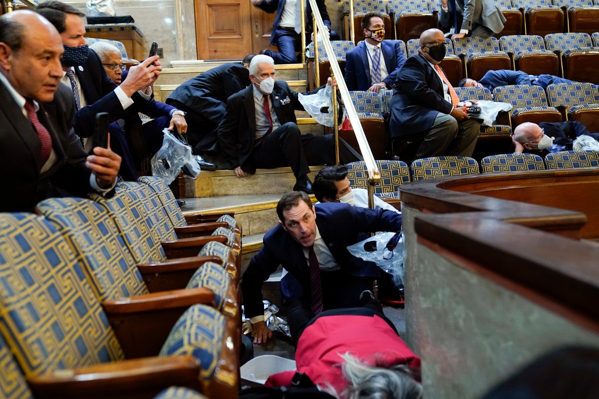 Members of Congress shelter in the House gallery as rioters try to break into the House Chamber at the U.S. Capitol on Jan. 6, 2021, in Washington. (AP Photo/Andrew Harnik, File)