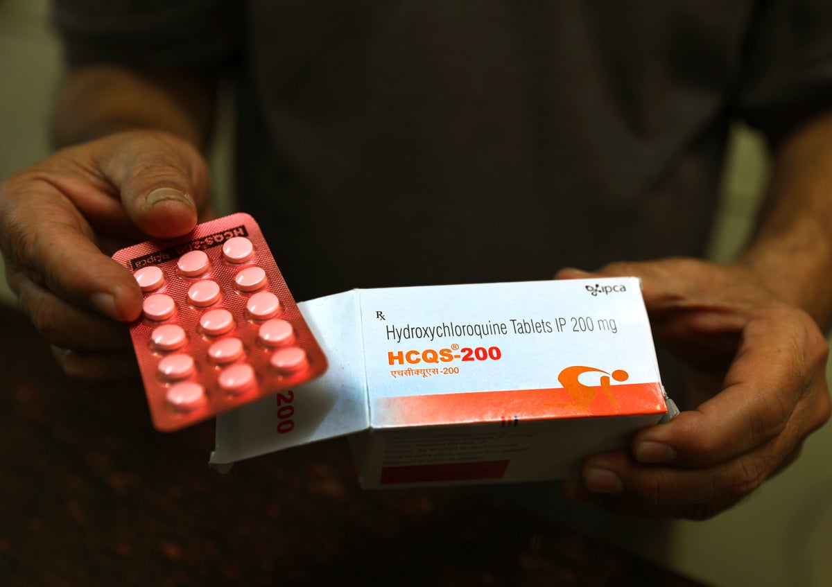 In this April 9, 2020 file photo, a chemist displays hydroxychloroquine tablets in New Delhi, India. U.S. regulators are revoking emergency authorization for malaria drugs promoted by President Donald Trump for treating COVID-19. The Food and Drug Administration said Monday, June 15 that the drugs hydroxychloroquine and chloroquine are unlikely to be effective in treating the coronavirus. (AP Photo/Manish Swarup, File)