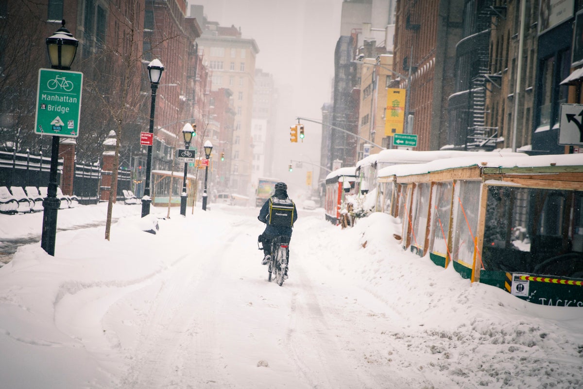 A bicycle food delivery worker rides his bike through Manhattan's Soho neighborhood, Monday, Feb. 1, 2021. (AP Photo/Robert Bumsted)
