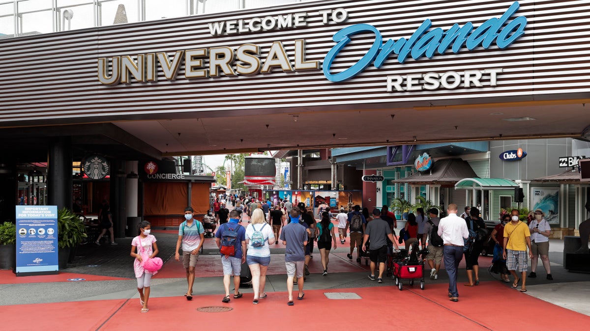 In this Wednesday, June 3, 2020 photo, visitors arrive at Universal Studios Wednesday, June 3, 2020, in Orlando, Fla. The Universal Studios theme park has reopened for season pass holders and will open to the general public on Friday, June 5. (AP Photo/John Raoux)