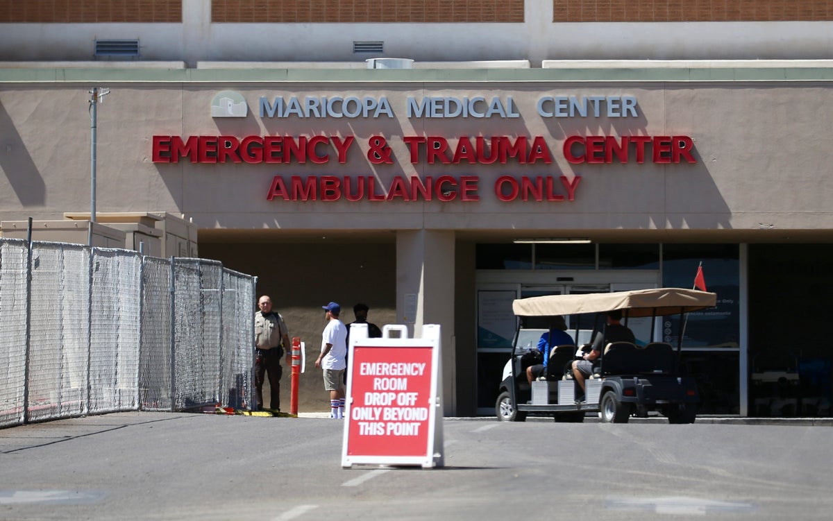 The emergency room entrance at Valleywise Health Center hospital is shown Wednesday, June 10, 2020, in Phoenix, as Arizona hospitals that are expected to be able to treat new cases of coronavirus without going into crisis mode were above 80% capacity Tuesday, a milestone that should trigger an automatic stop to elective surgeries at affected hospitals. The state is dealing with a surge in virus cases and hospitalizations that experts say is likely tied to Gov. Doug Ducey's ending of statewide closure orders in mid-May. (AP Photo/Ross D. Franklin)