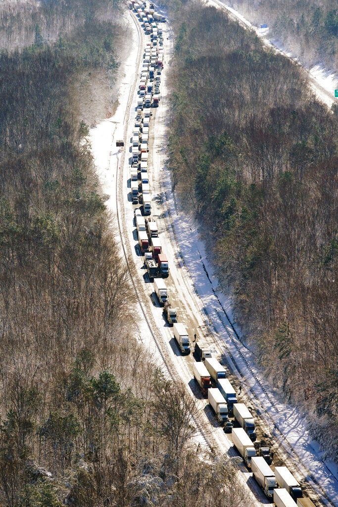 Cars and trucks are stranded on sections of Interstate 95 Tuesday Jan. 4, 2022, in Carmel Church, Va. Close to 48 miles of the Interstate was closed due to ice and snow. (AP Photo/Steve Helber)