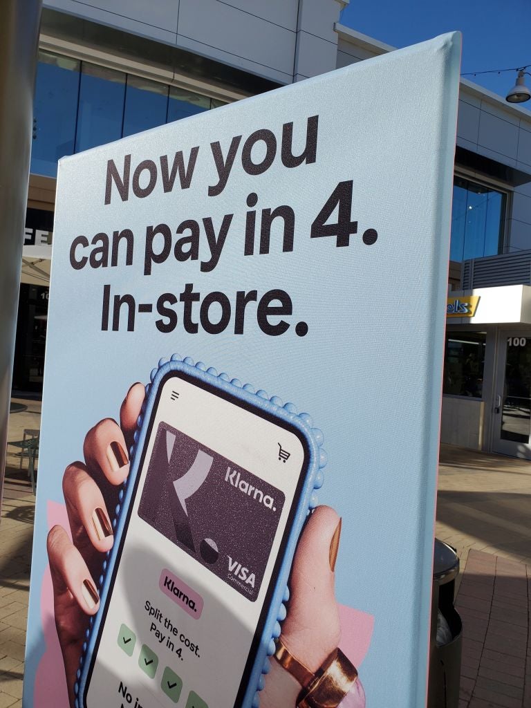 An advertisement for the Klarna Buy Now Pay Later app is visible in Broadway Plaza shopping center in Walnut Creek, California, November 24, 2021. (Photo by Smith Collection/Gado/Getty Images)