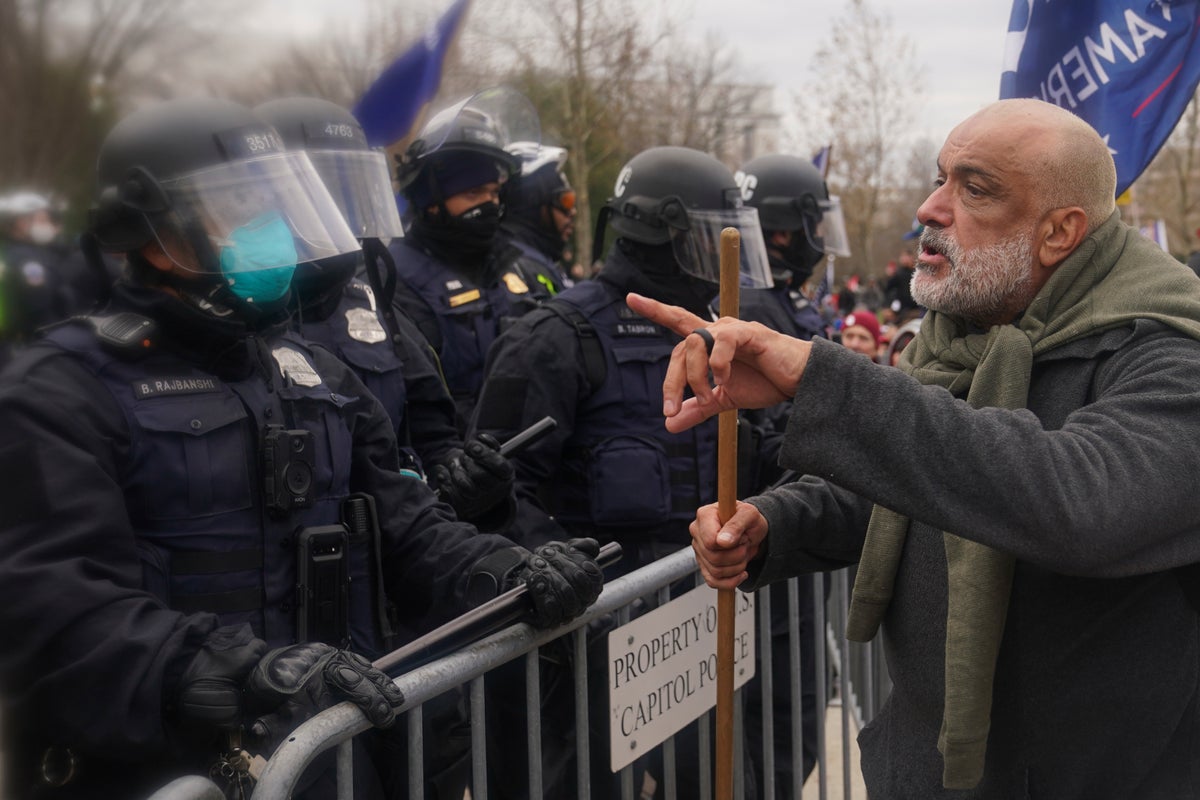 A protester confronts Washington Metropolitan Police department officers as they assist U.S. Capitol Police with rioters on the West Front of the U.S. Capitol on Jan. 6, 2021, in Washington. (AP Photo/John Minchillo)