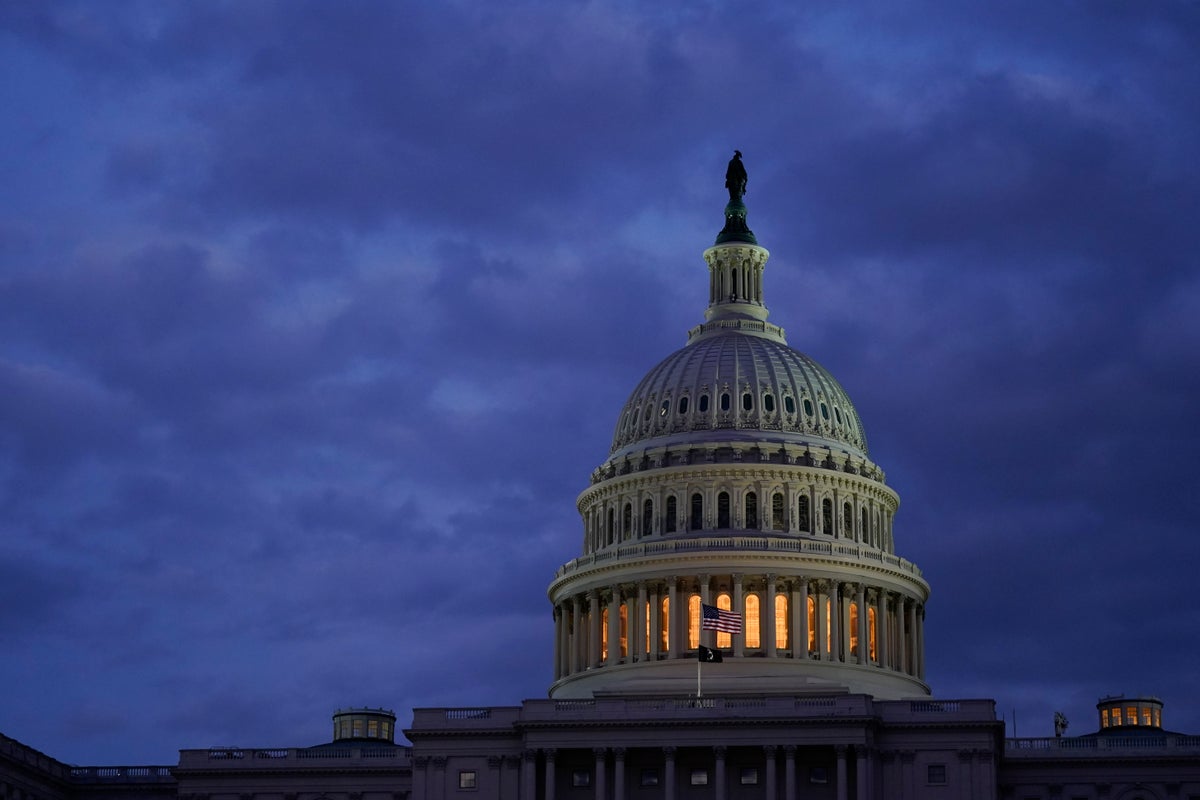 Light shines from the U.S. Capitol dome after sunset, Tuesday, Jan. 25, 2022, in Washington. (AP Photo/Patrick Semansky)