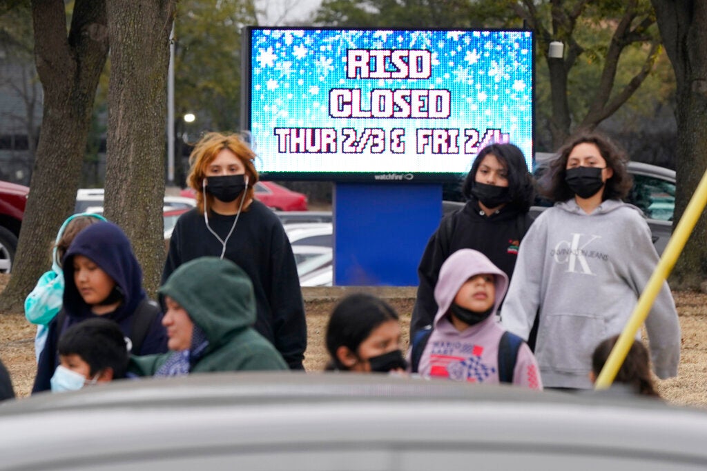 A sign tells that the school has been canceled due to impending winter weather in Dallas, Wednesday, Feb. 2, 2022. North Texas school districts called off classes for the next two days in anticipation of winter weather that sweeps in this evening. (AP Photo/LM Otero)