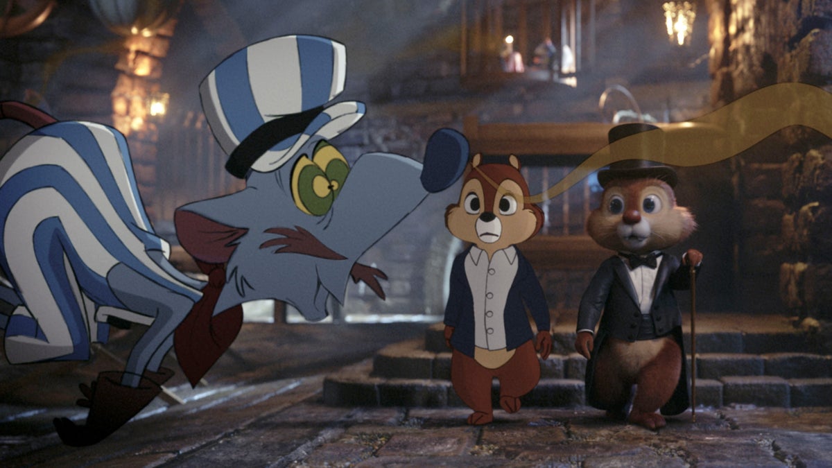 This image released by Disney+ shows Chip, voiced by John Mulaney, center, and Dale, voiced by Andy Samberg, right, in a scene from 