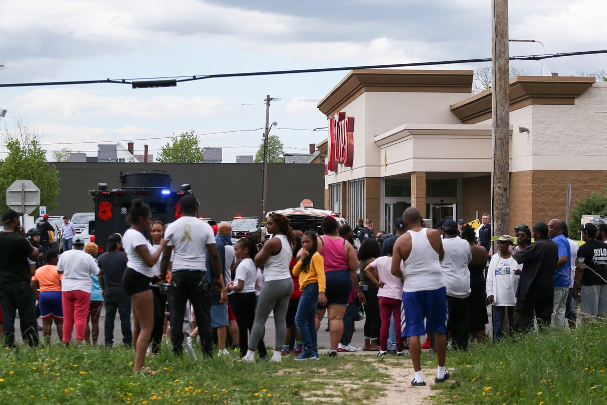 A crowd gathers as police investigate after a shooting at a supermarket on Saturday, May 14, 2022, in Buffalo, N.Y. Multiple people were shot at the Tops Friendly Market. Police have notified the public that the alleged shooter was in custody. (AP Photo/Joshua Bessex)