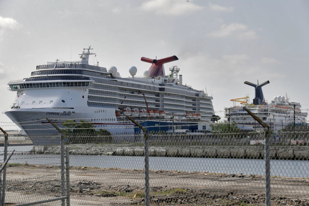 Carnival Cruise ships are docked at the Port of Tampa Thursday, March 26, 2020, in Tampa, Fla. Thousands of cruise ships employees are not working in an attempt to stop the spread of the coronavirus. (AP Photo/Chris O'Meara)